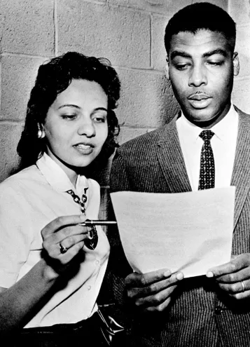 Diane Nash, left, Fisk junior and chairmen of the student protest group, and the Rev. Kelly Smith, pastor of the First Baptist Church and president of the Nashville Christian Leadership council, confer before releasing a statement to reporters on their views of the sit-in demonstrations April 9, 1960.
Photo credit: Gerald Holly / The Tennessean